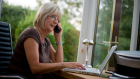 IS Guess the love song lyrical - middle aged woman on computer and phone.jpg