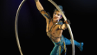 Aerial High Bar: Three high bars set more than 40 feet above the stage form the aerial playground for daring acrobats to fly to and from the arms of mighty catchers, suspended by their knees on a cradle swing
