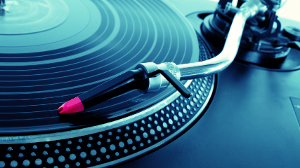 Turntable playing vinyl record with music.jpg