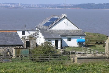 A farmhouse using solar panels for electricity and also heating water. A farmhouse using solar panels for electricity and also heating water.