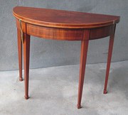 A MAHOGANY DEMILUNE CARD TABLE
