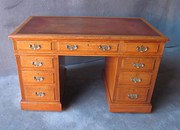 A SOLID OAK PEDESTAL DESK