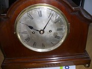 Bracket clock in a deep red ma