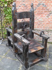 Unique oak and iron back to back torture chair.