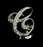 A diamond set C brooch