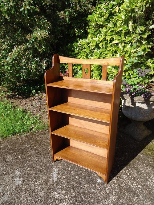 Arts & Crafts Oak bookcase with central heart.