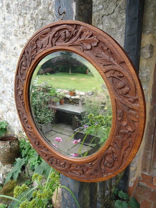 Arts & Crafts carved oak mirror with acorns