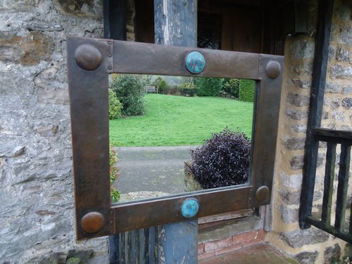 Arts & Crafts copper mirror with cabochons