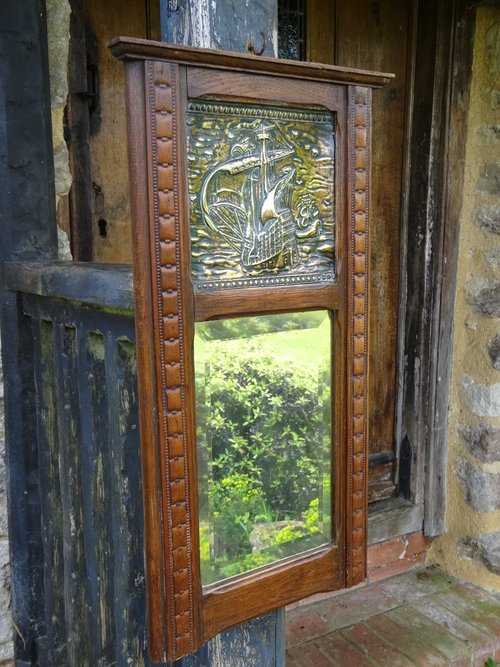Arts & Crafts oak framed mirror with brass ship