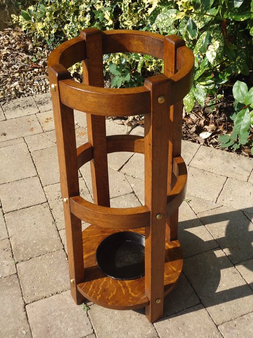 Arts & Crafts oak round stick stand with brass studs