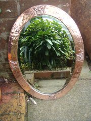 Arts & Crafts oval copper mirror.