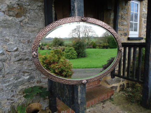 Arts & Crafts oval hammered copper mirror