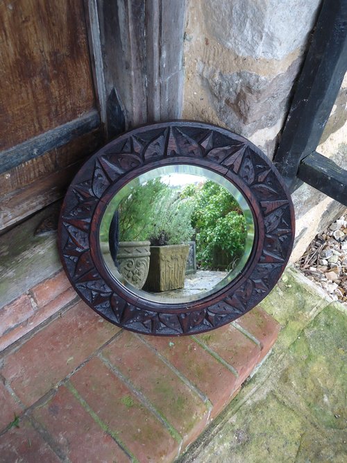 Arts & Crafts round carved bevelled mirror