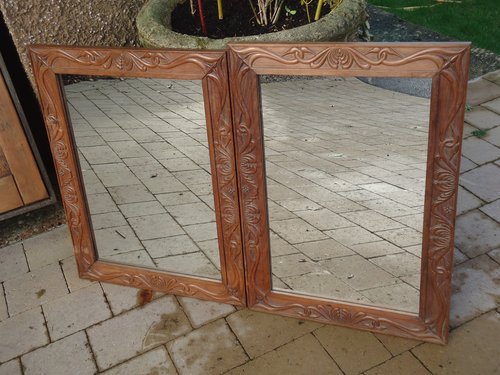Matched pair of Arts & Crafts carved mirrors