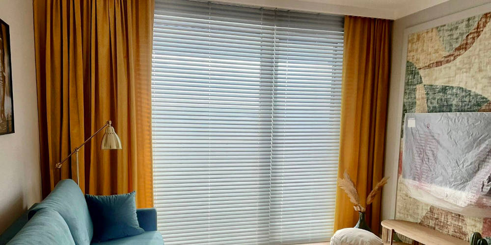 Białe żaluzje aluminiowe w salonie