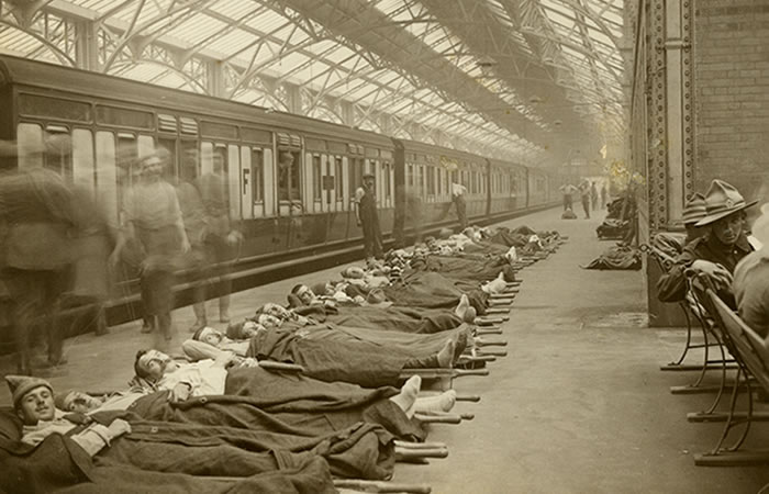 Soldiers on a station platform having been unloaded from an Ambulance Carriage