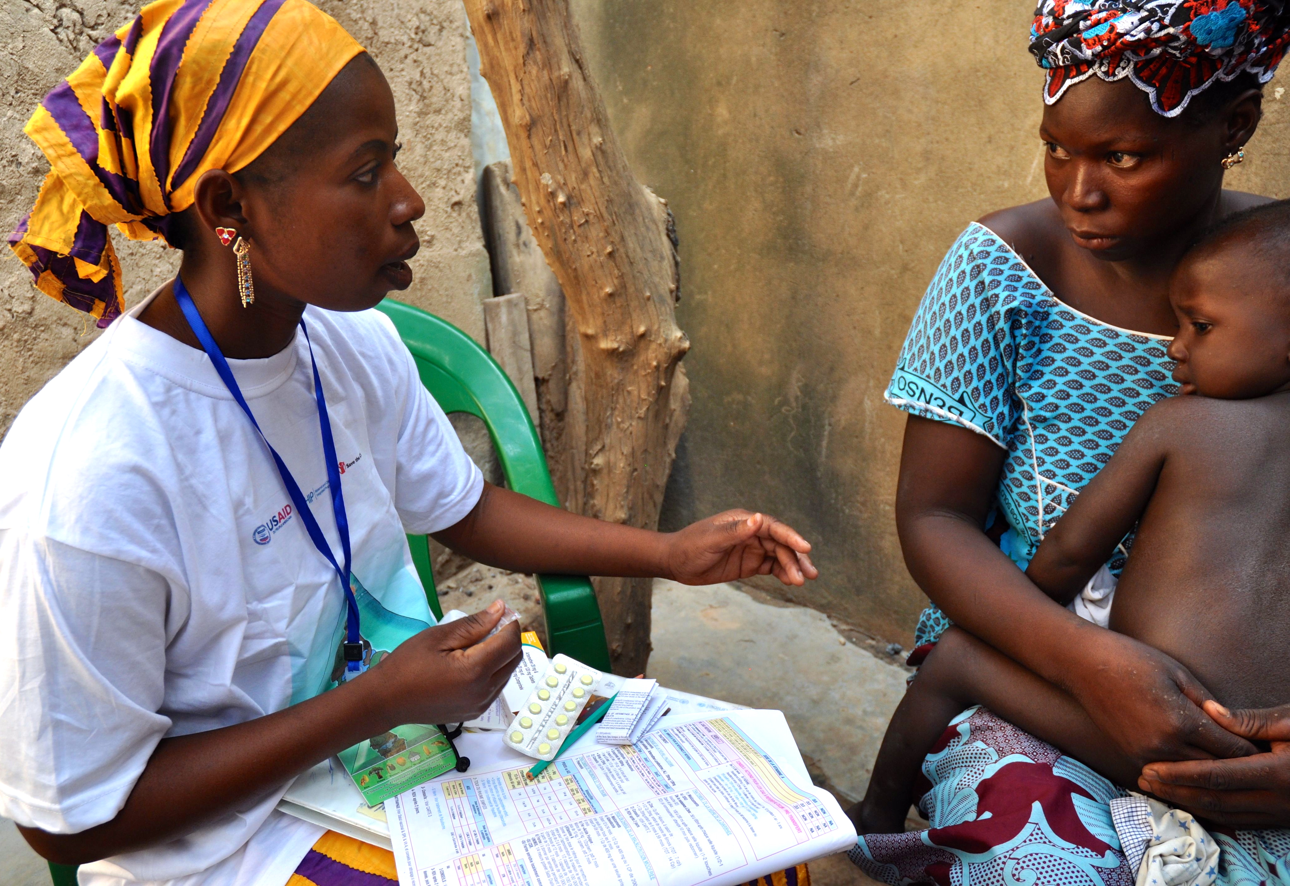 Delivery of malaria treatment by community health worker in Djénébougou, Mali.