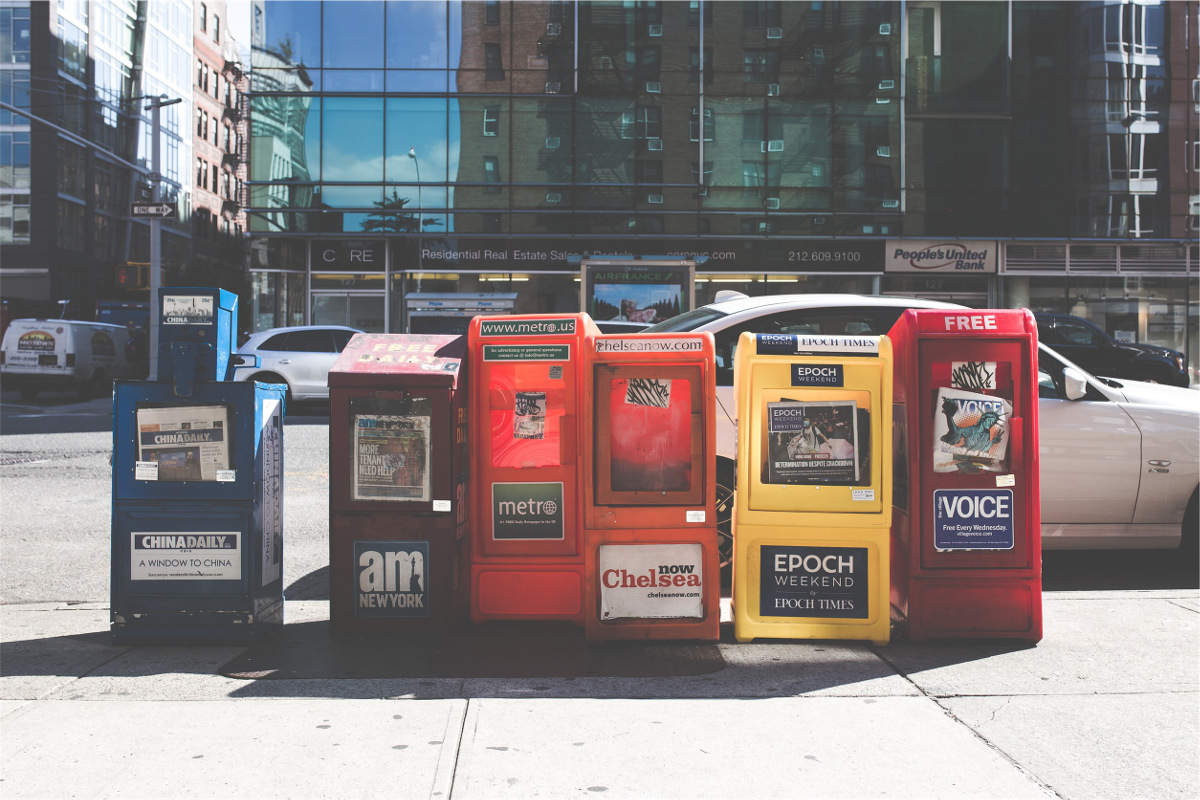 photograph picture of newspaper boxes on a street