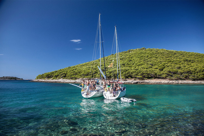Group of friends enjoying sailing holidays in a sailboat in Central Dalmatia coast
