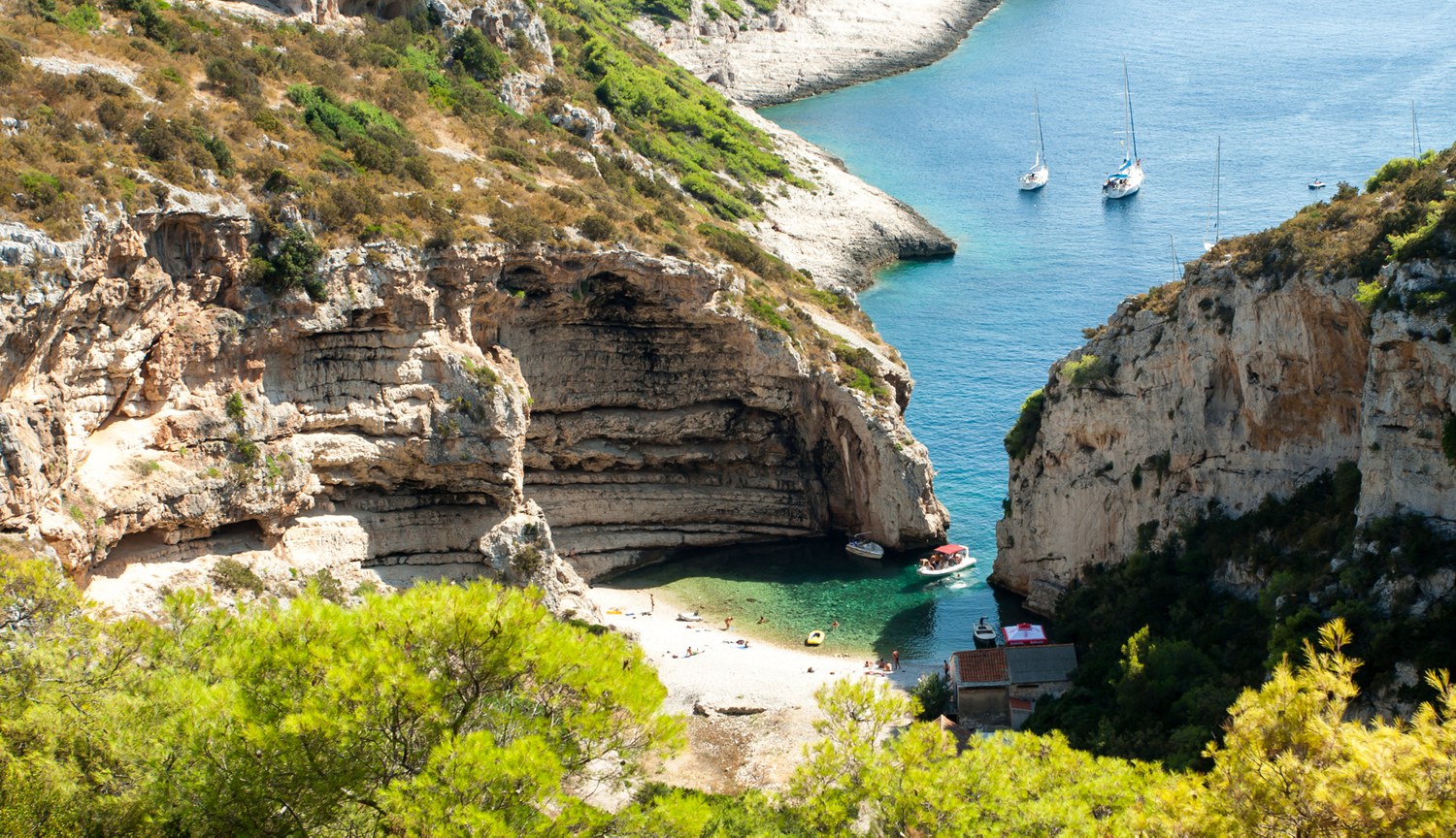 Rental boats anchored in cove Stiniva at south of Vis island in Central Dalmatia (Croatia)