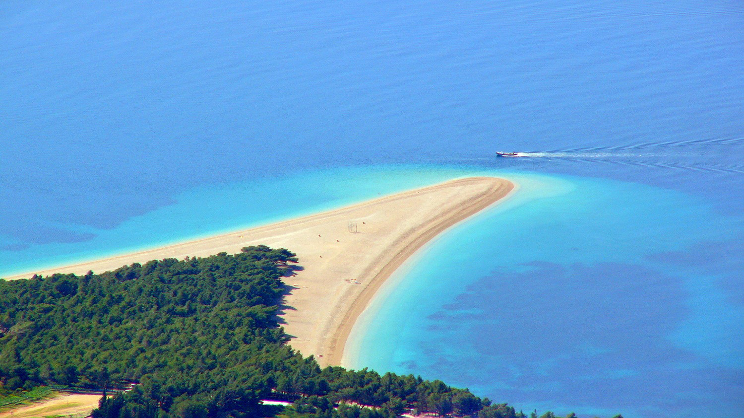 Motoryacht sailing around the famous Zlatni Rat beach in the croatan island of Brac