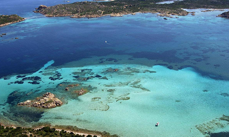 Speedboat in tuquoise waters of cala del Cavalliere in Budelli island (La Maddalena, Sardinia)