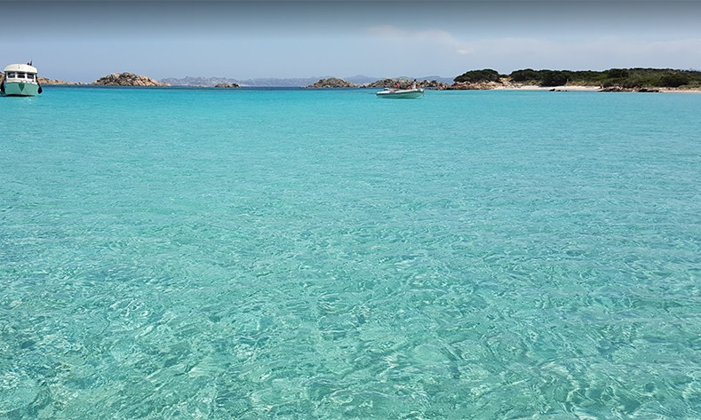 Motorboats anchored in cala del Cavalliere in the island of Budelli (La Maddalena, Sardinia)