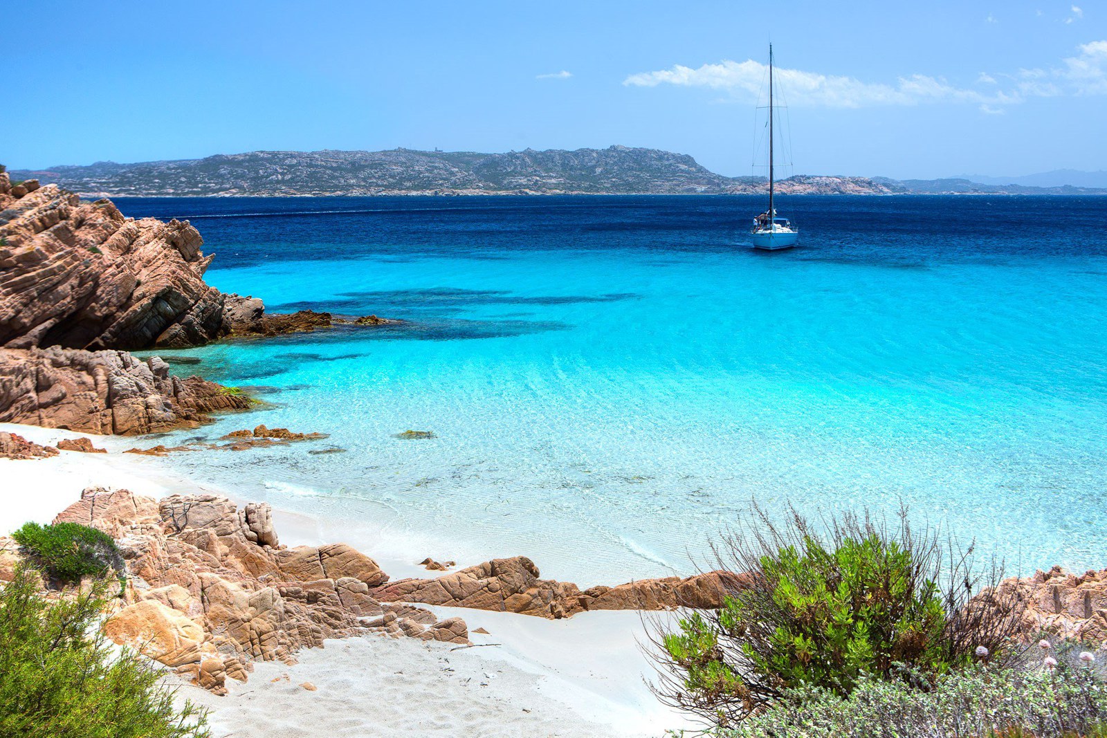 Sailboat anchored in the paradise Cala Soraya in Spargi island (La Maddalena)