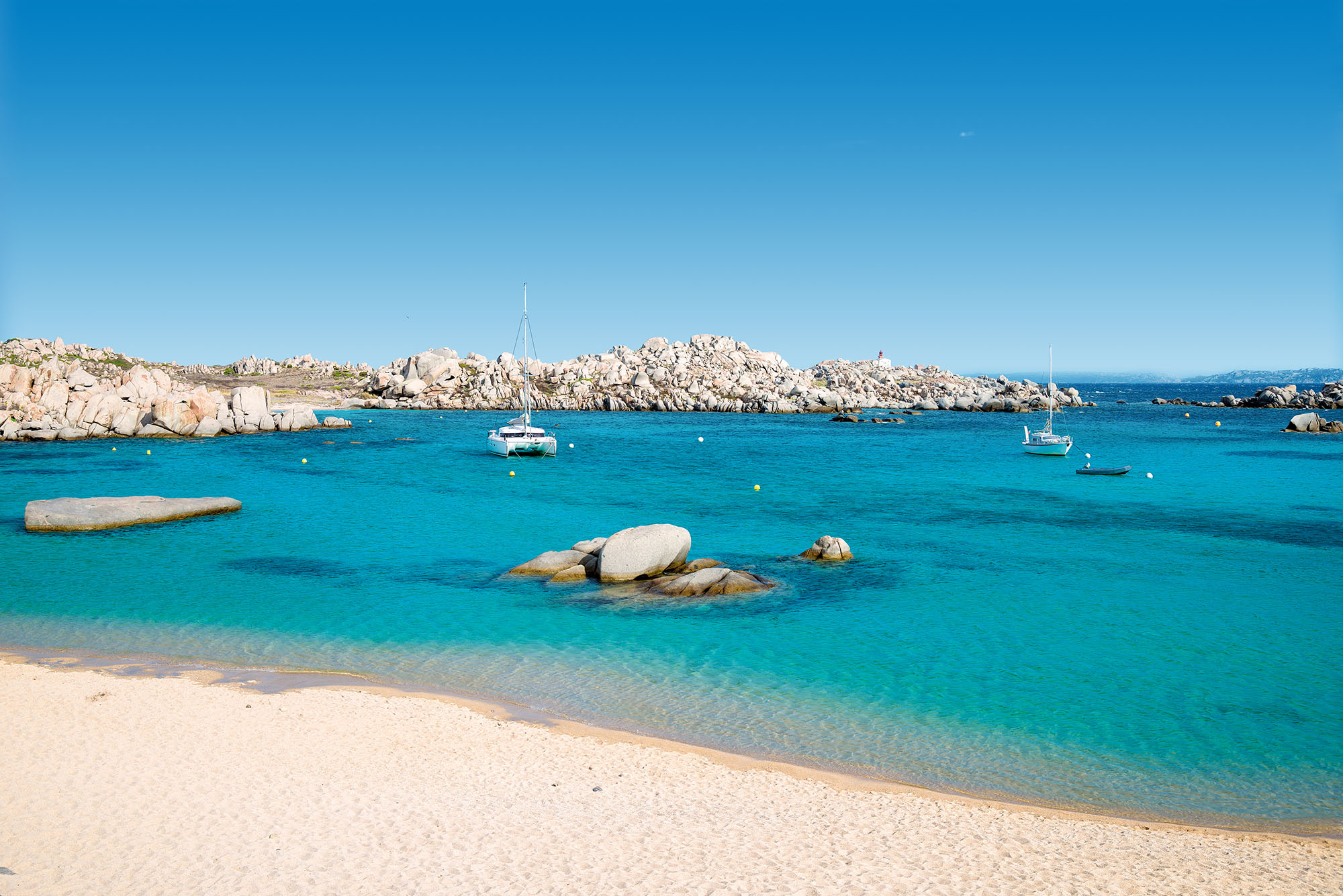 Catamaran and sailboat anchored in Lavezzi island (Corsica)