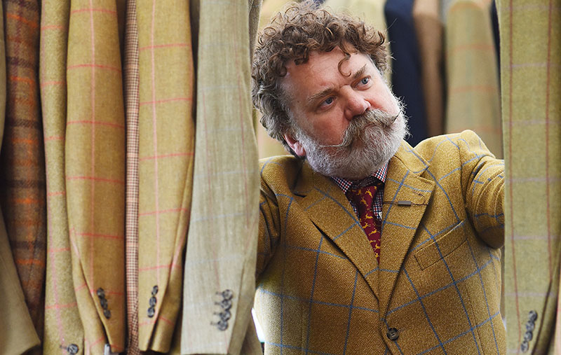 Shopping for tweed. A country gent eyes up the tweed at the Game Fair.