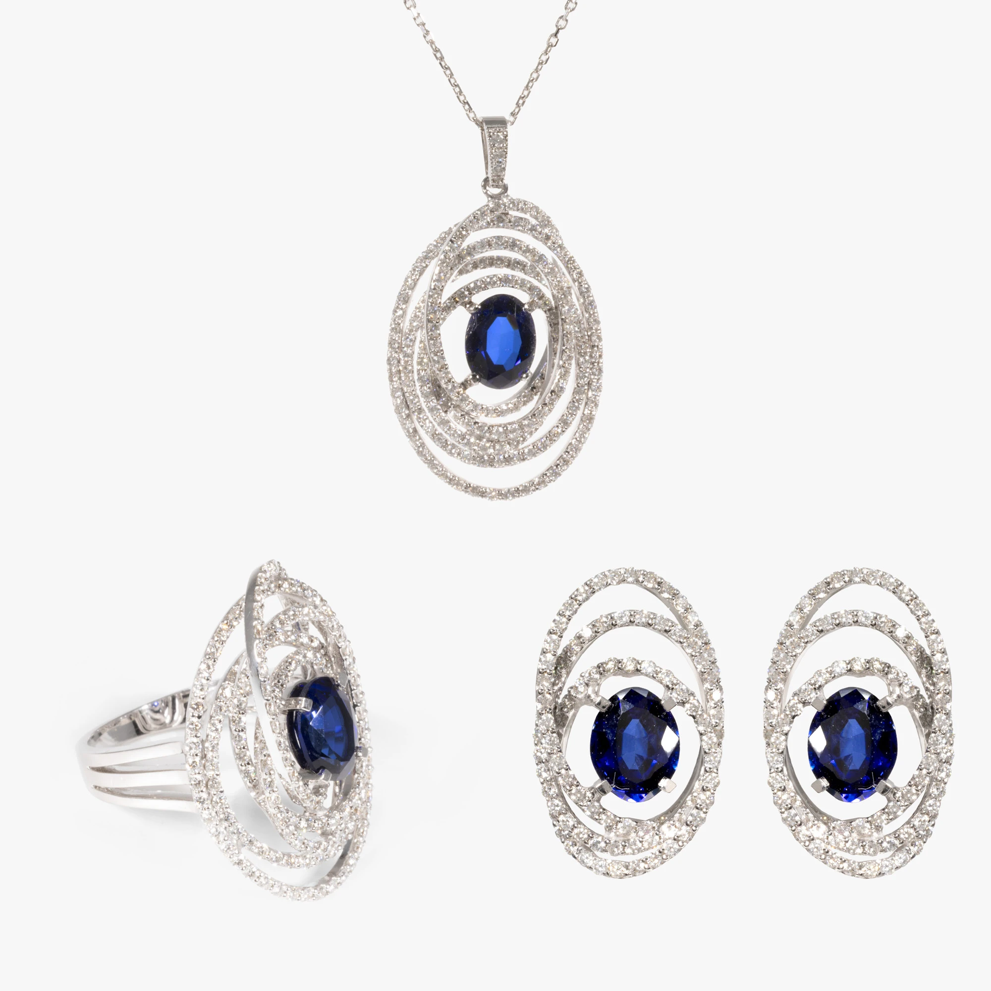 White gold set consisting of a chain with pendant, earrings, and a ring, decorated with diamonds