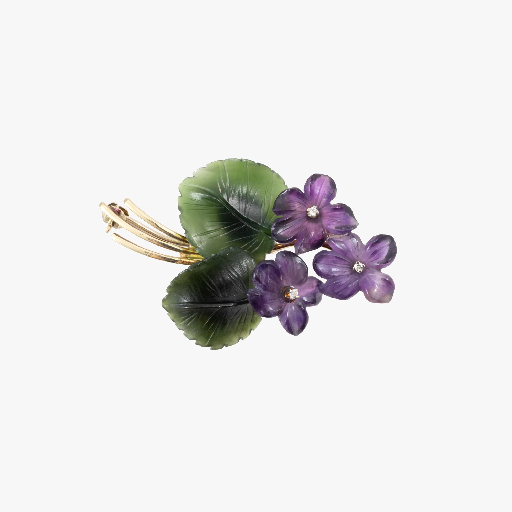 Gold brooch decorated with diamonds, carved amethysts, and nephrite