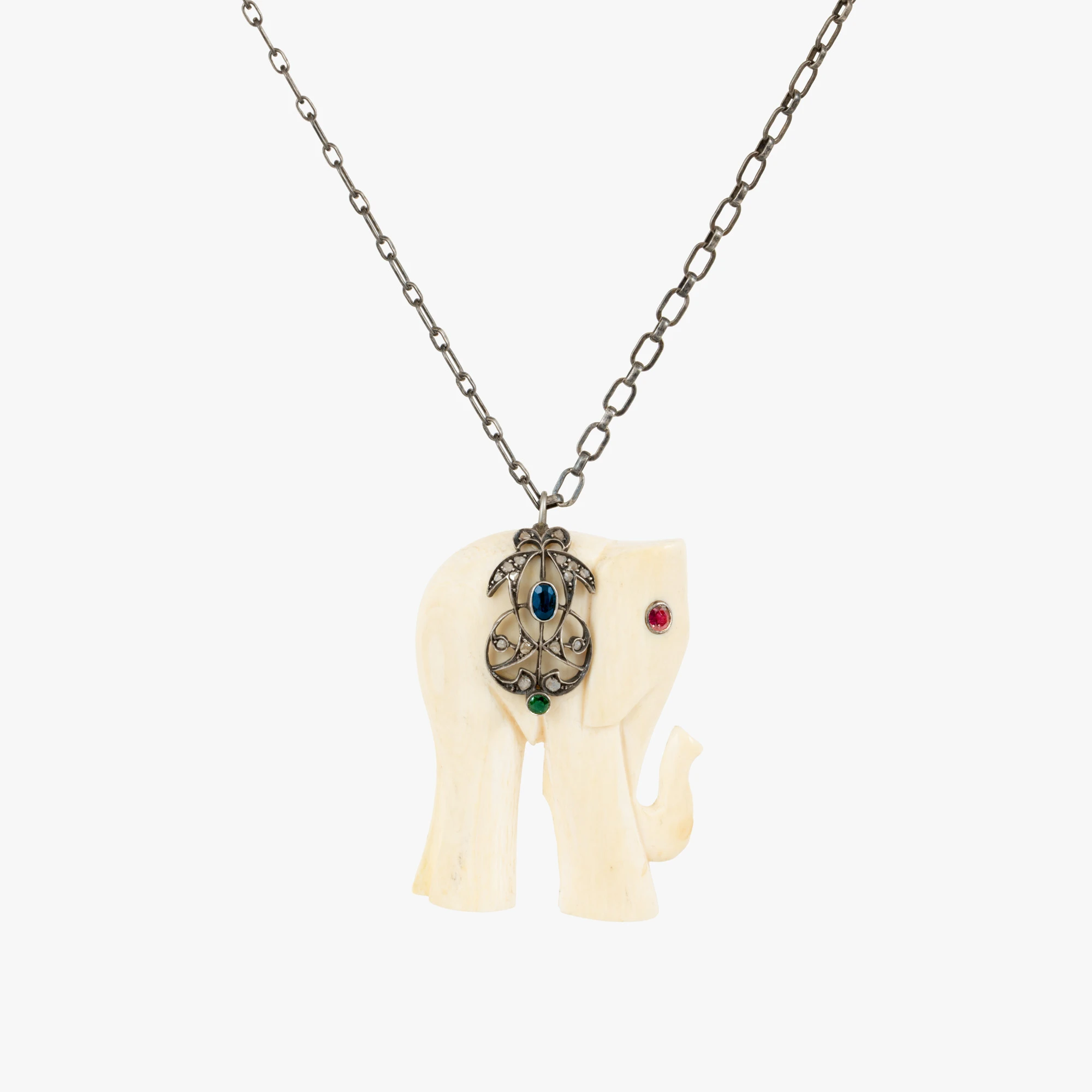 Silver chain with an elephant-shaped pendant, made of ivory, decorated with ruby, emerald, sapphire, and diamonds