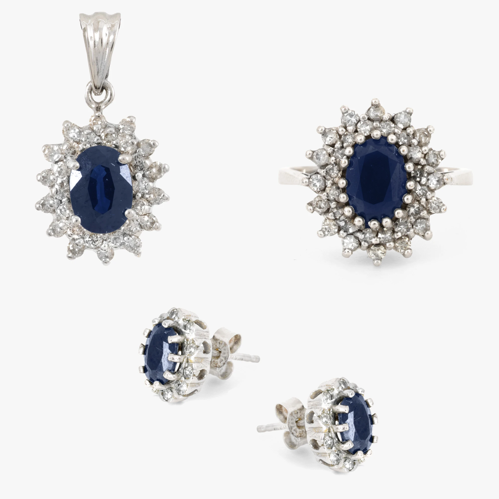 White gold set consisting of a pair of earrings, a ring, and a pendant, decorated with sapphires and diamonds