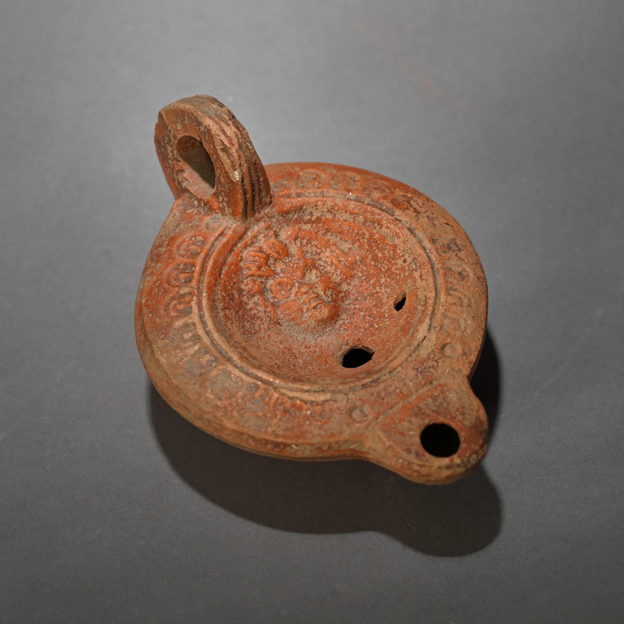 Ceramic lamp, decorated with Gorgona head, Roman era, 2nd century