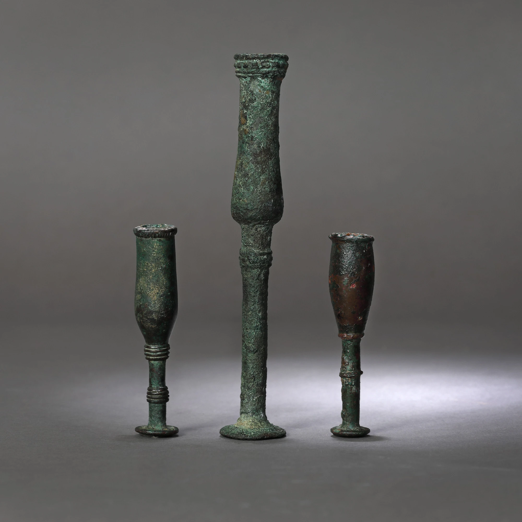 Three bronze candlesticks, possibly Luristan, Persia, the first part of the first millennium B.C.