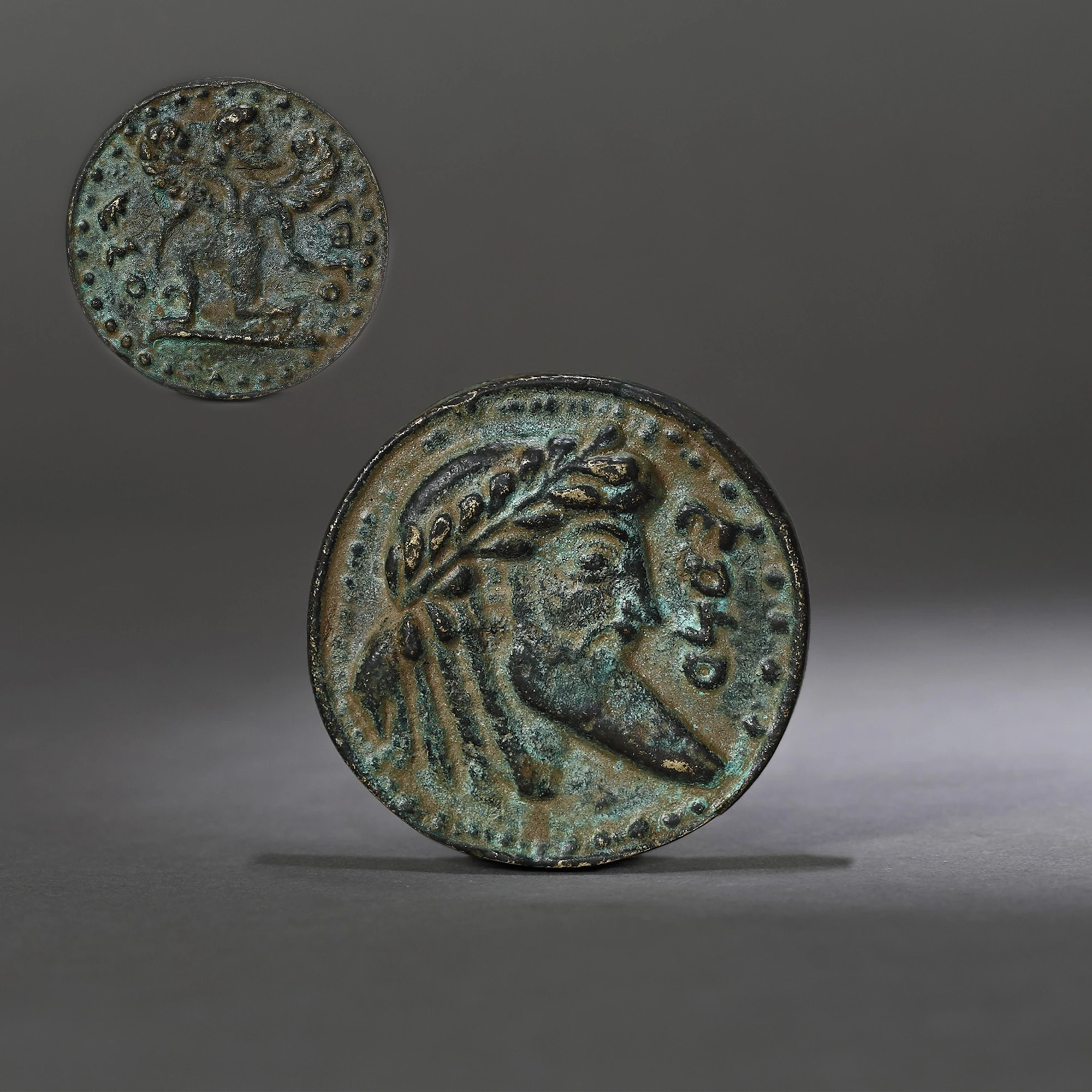 Bronze medal, illustrating a male hero, and on the reverse the image of a winged deity, probably a copy of the Hellenistic original, used as press-papier, 18th-19th century