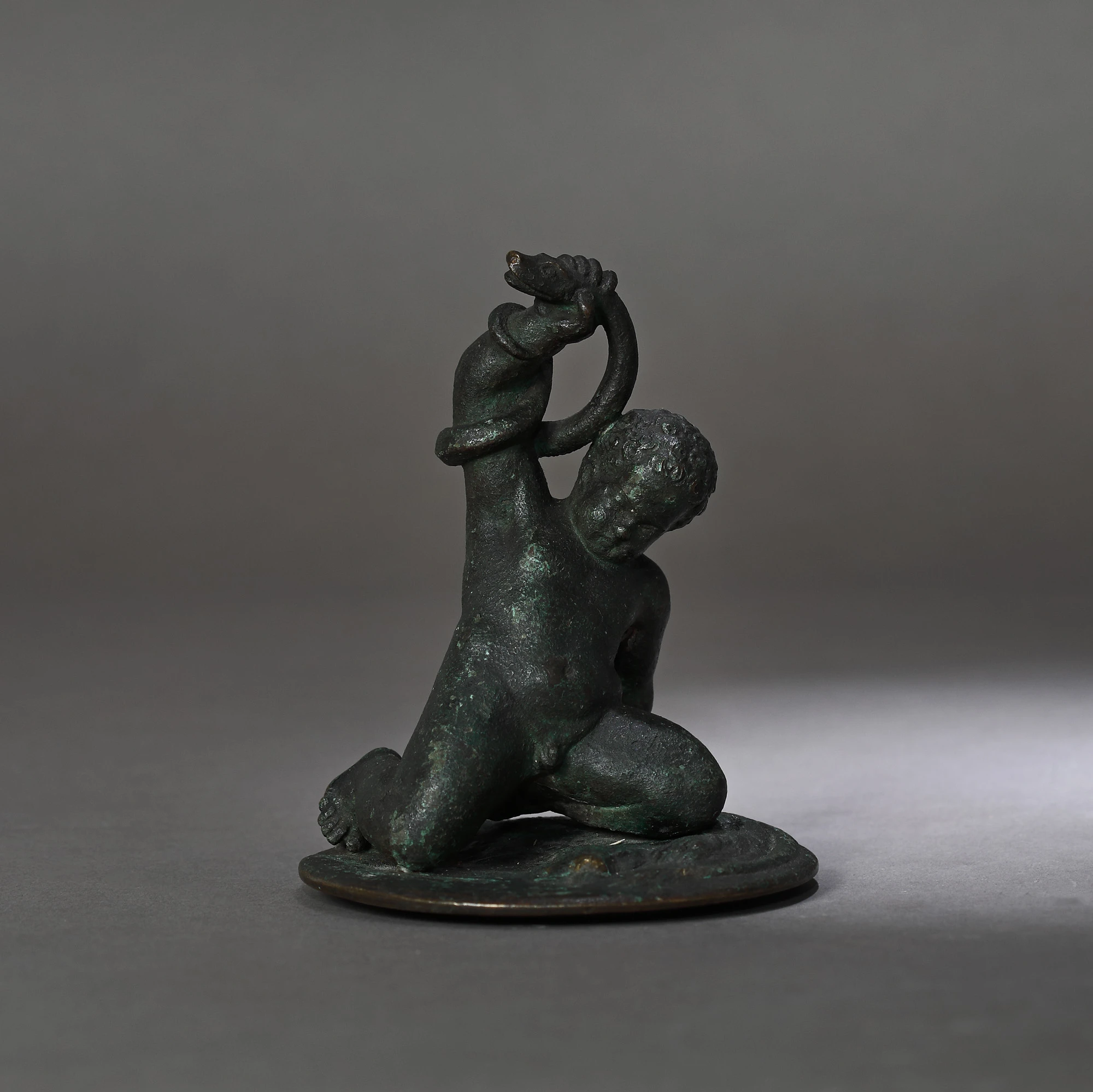 Statuette depicting the child Hercules fighting the serpents sent by Hera, on a pedestal decorated with the fur of the lion from Nemea, probably a bronze reproduction of a Roman work, 18th-19th century