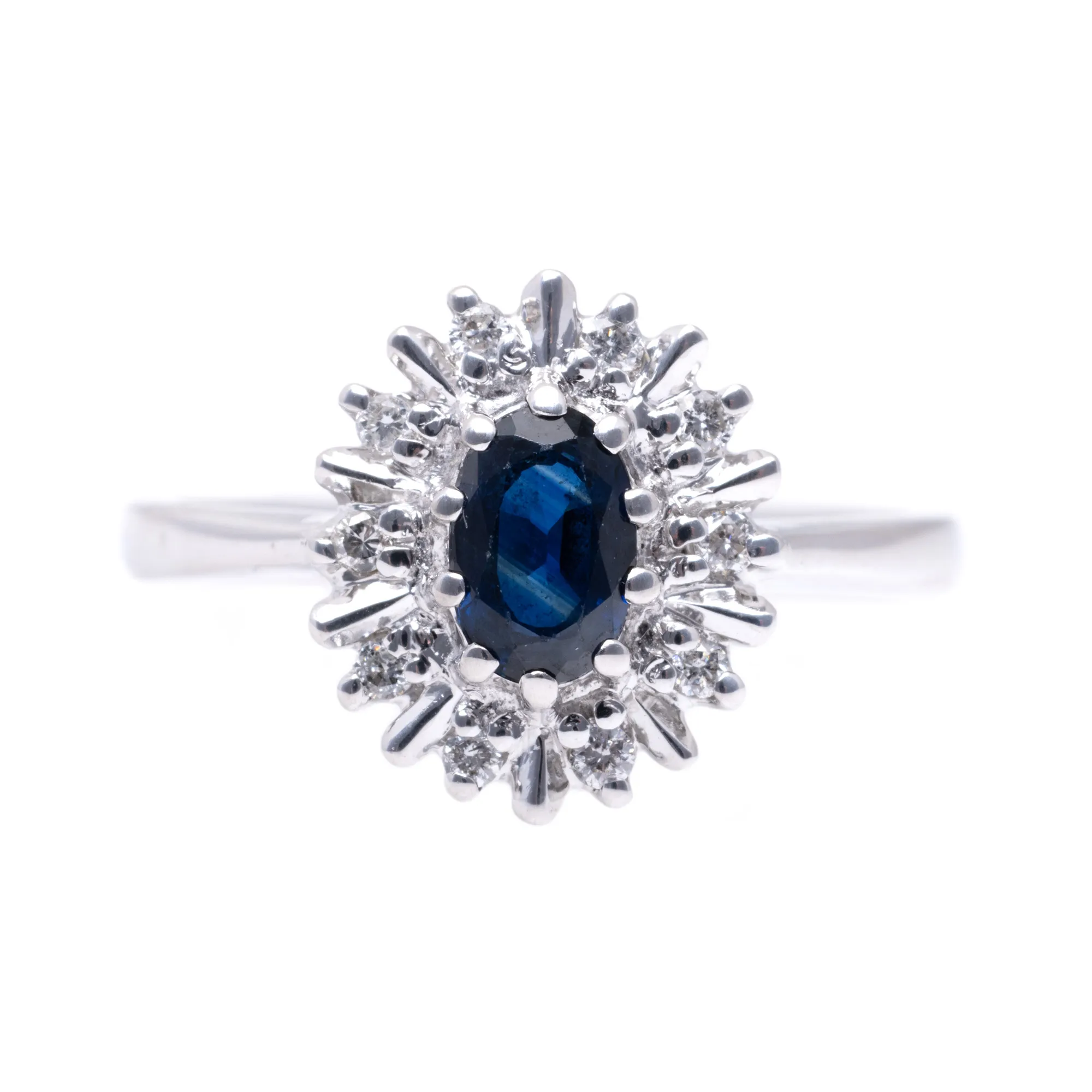 White gold ring, decorated with a central sapphire, surrounded by diamonds