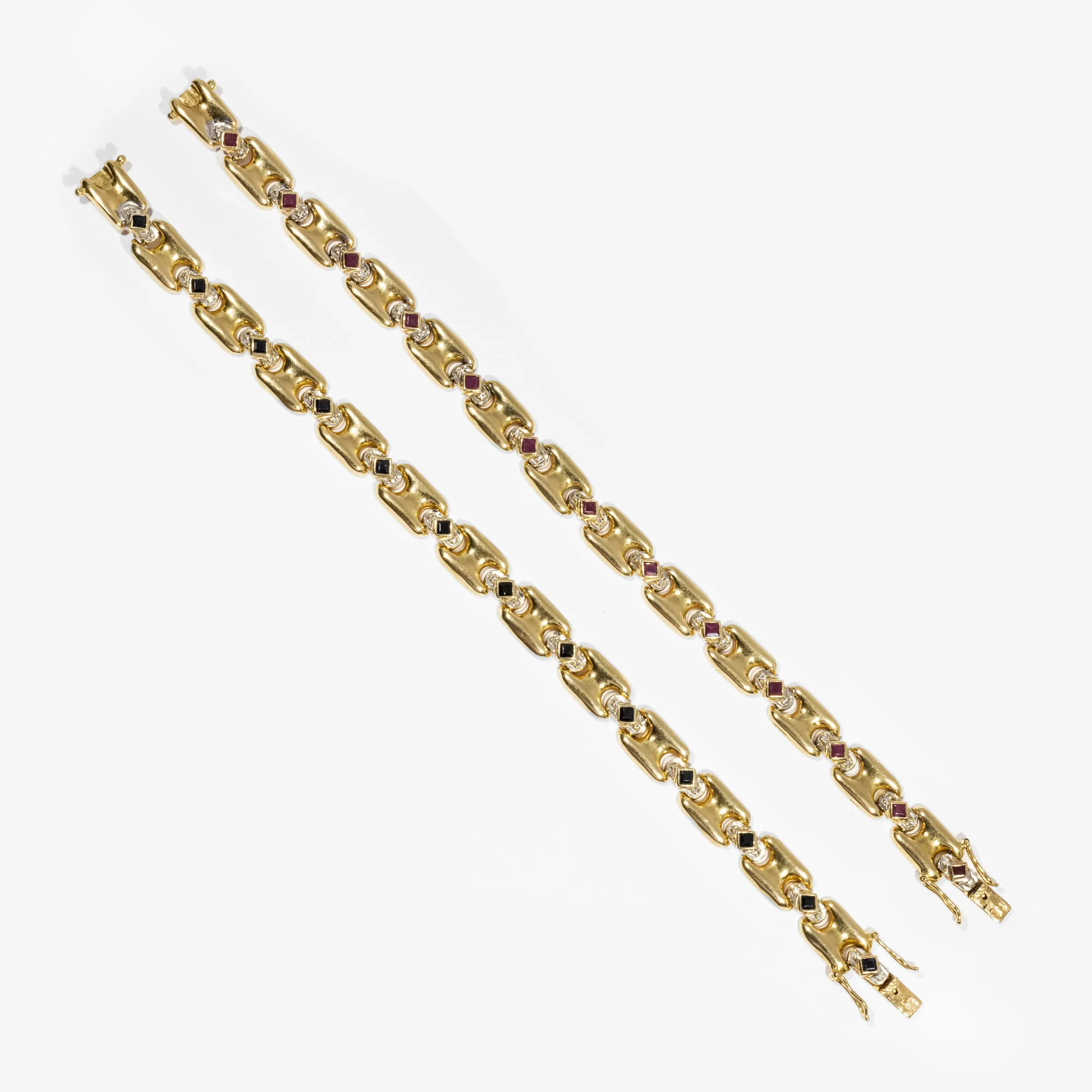 Pair of gold bracelets, decorated alternately with rubies and diamonds, sapphires and diamonds.