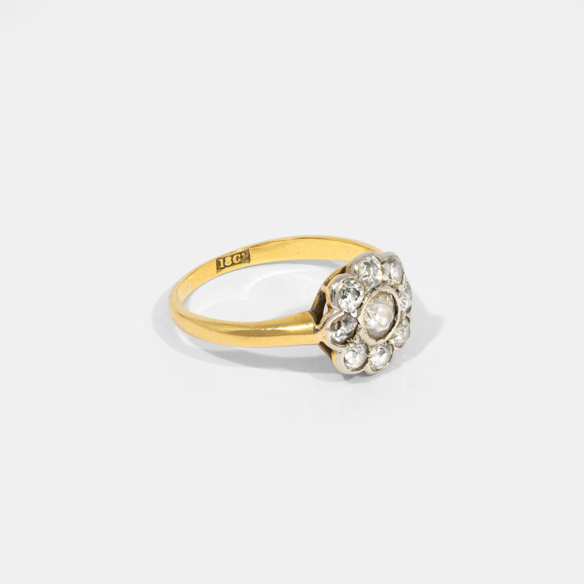 Gold ring in the shape of a flower, decorated with diamonds