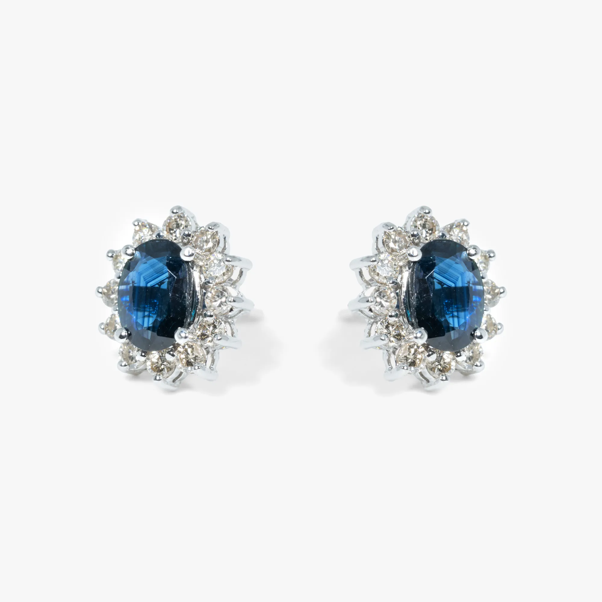 Pair of white gold earrings, adorned with sapphires surrounded by diamonds