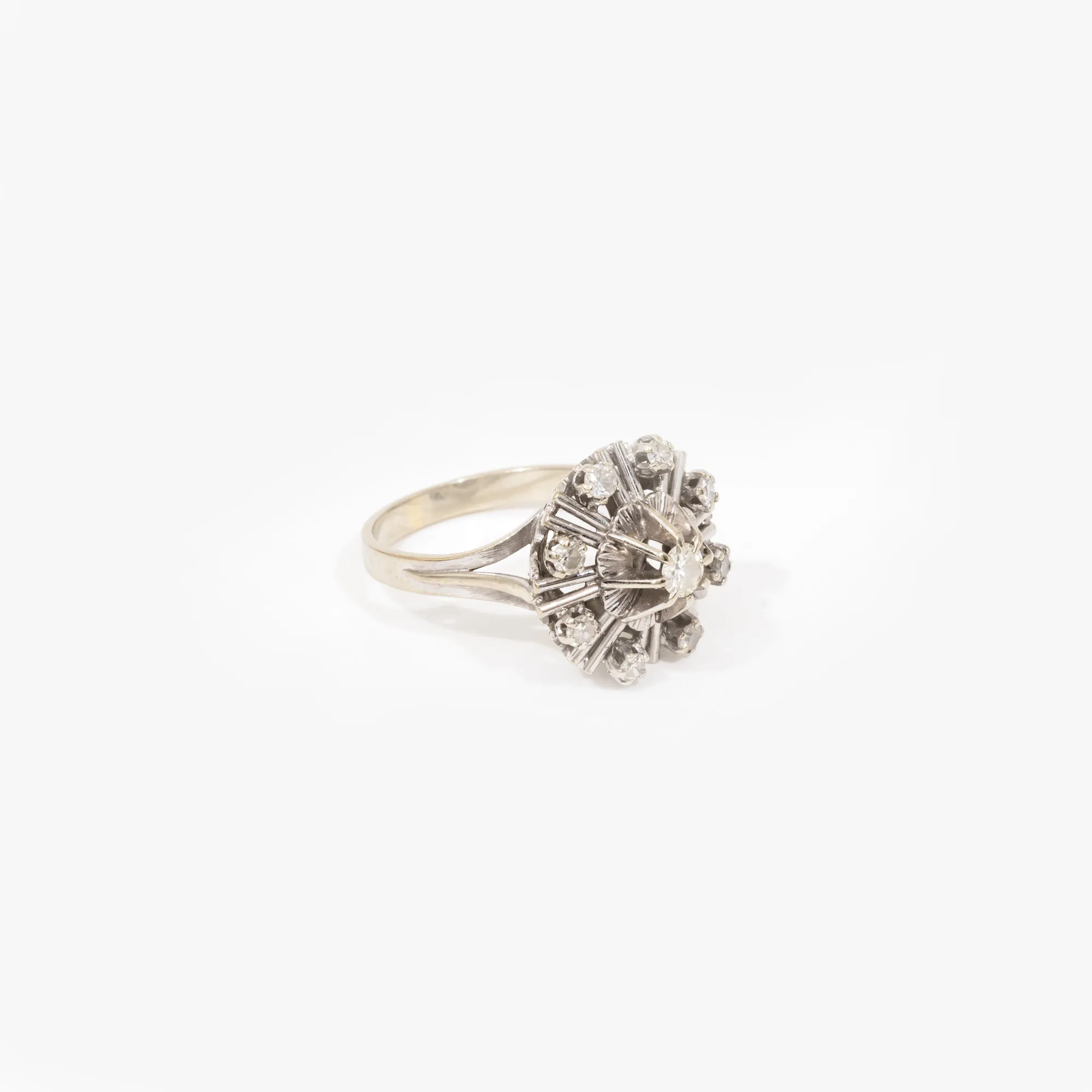 White gold ring in the shape of a flower, decorated with diamonds
