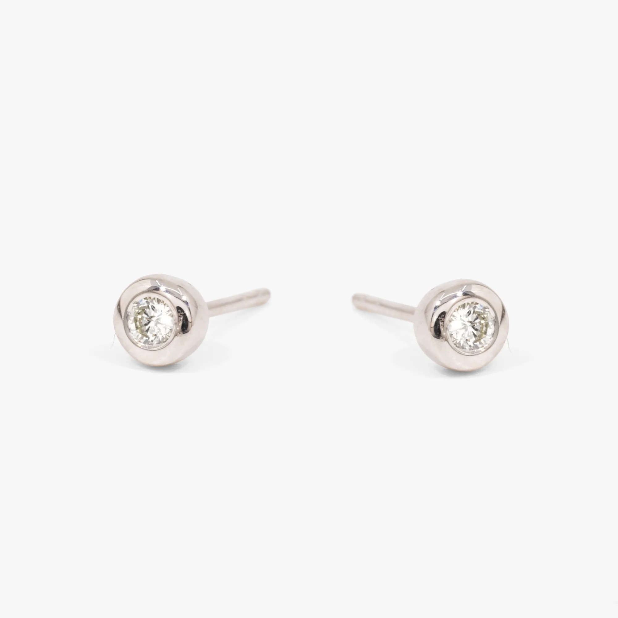 Pair of white gold earrings, decorated with two inset diamonds