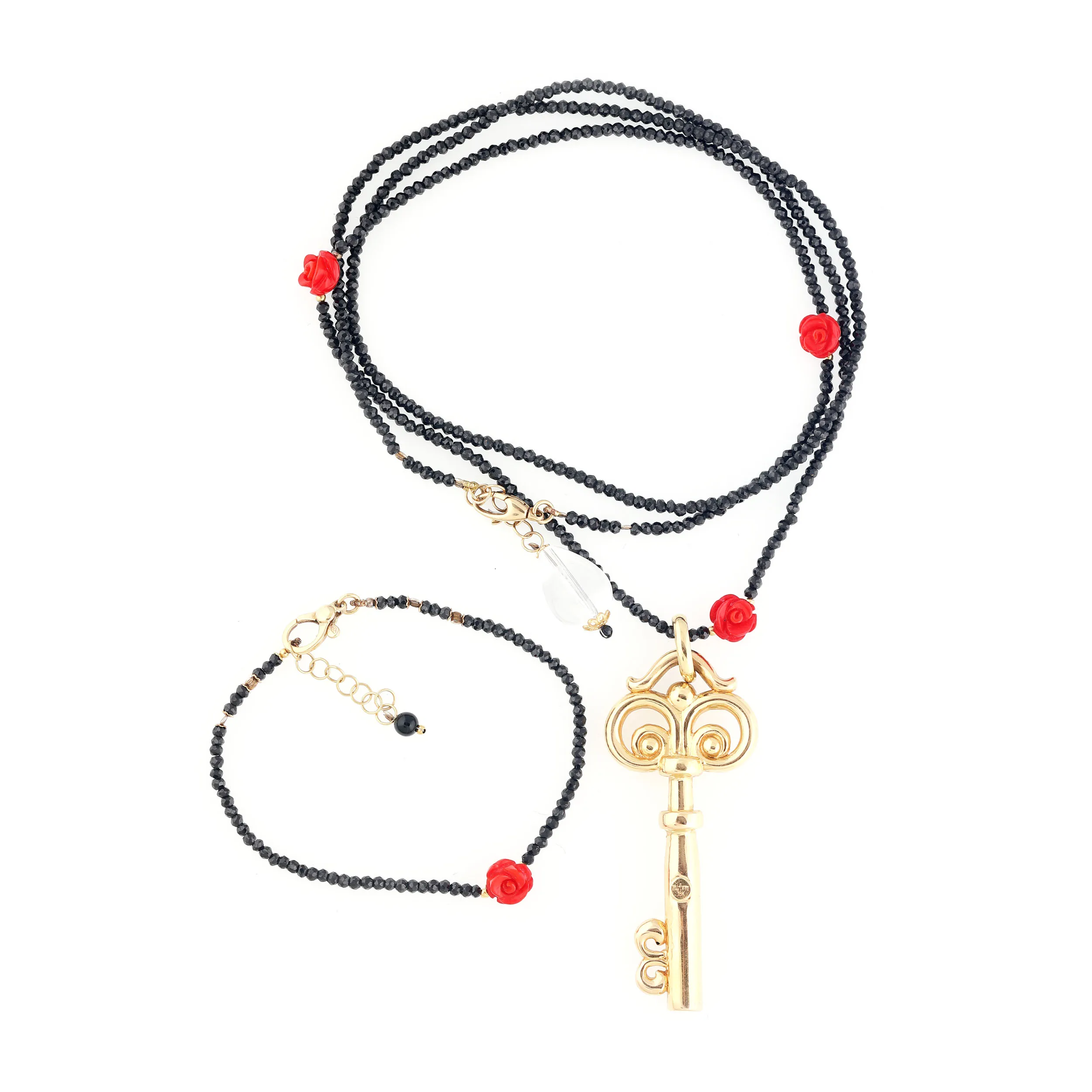 Set made up of bracelet and necklace, decorate with onyx beads, corals under the form of roses, and key pendant made of gold