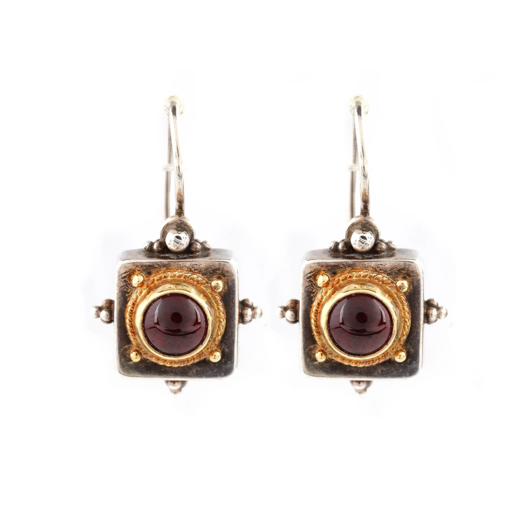 Pair of silver and gold earrings decorated with cabochon garnets