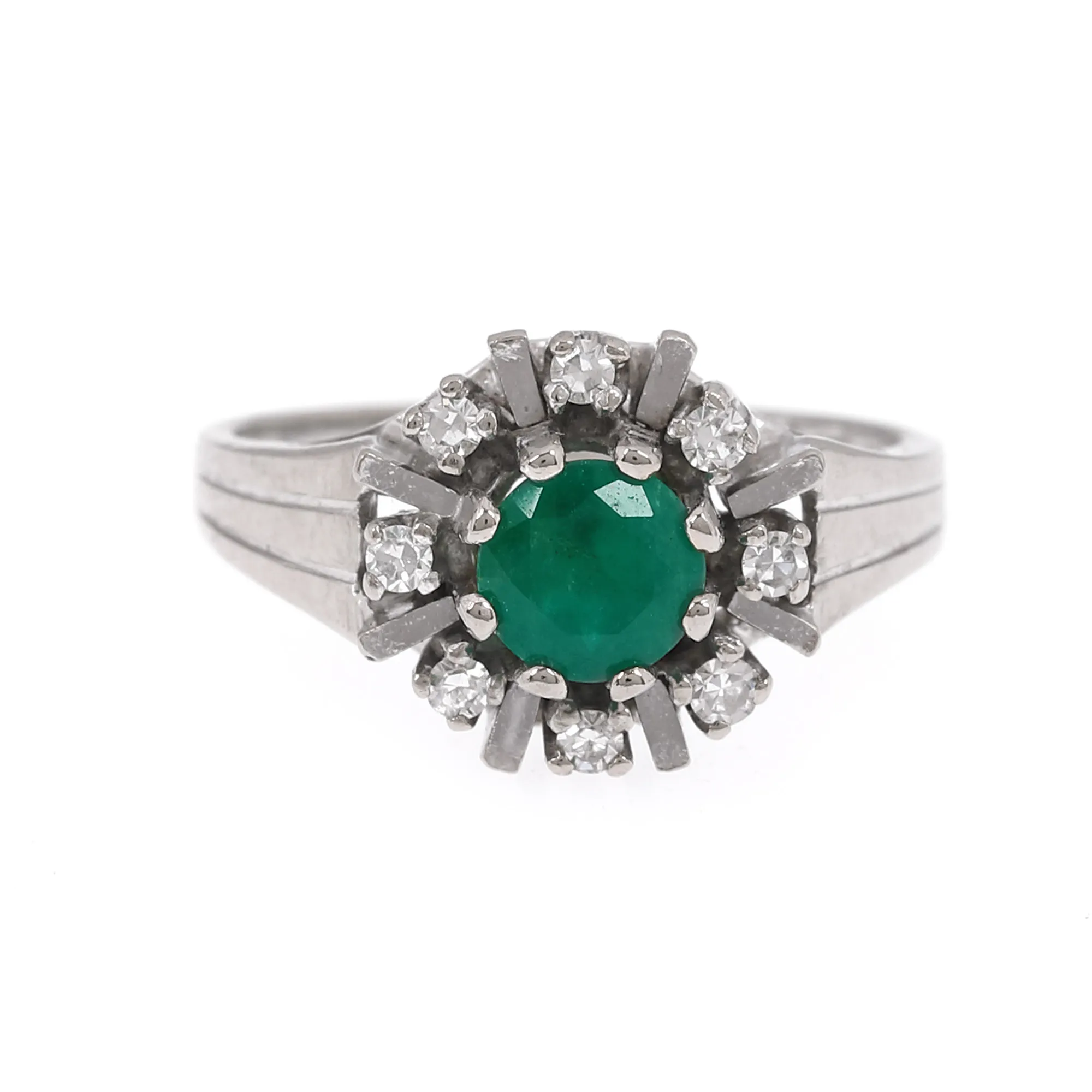 White gold ring, decorated with emerald surrounded by diamonds