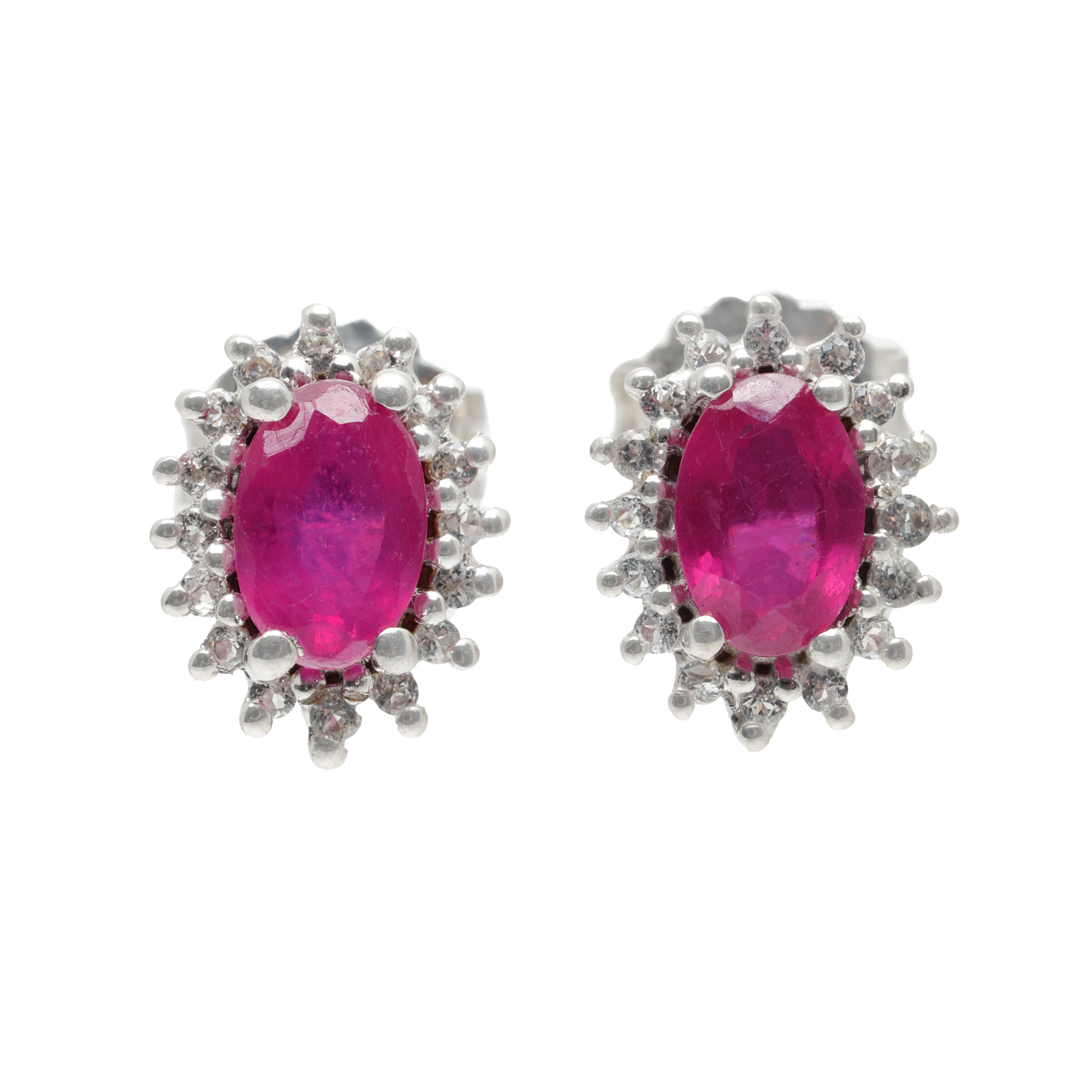 Pair of silver earrings, decorated with rubies and topazes