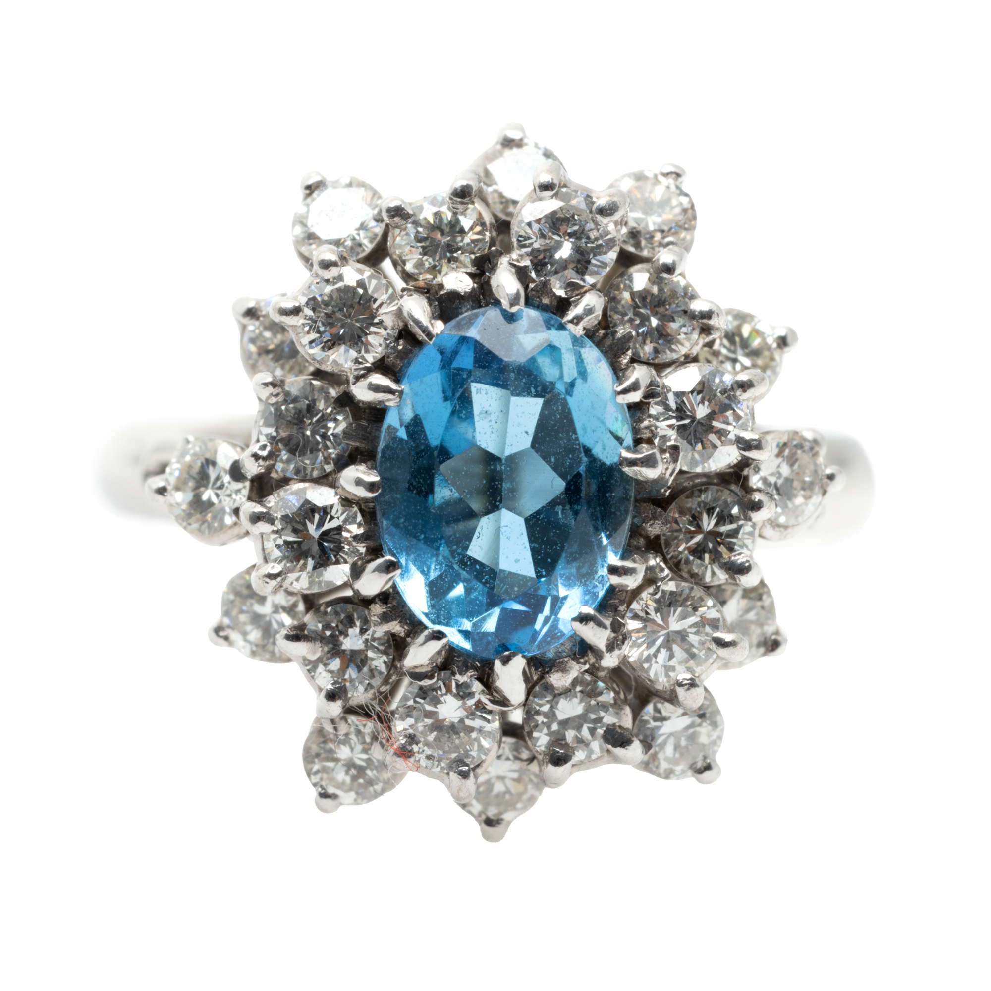White gold ring, decorated with aquamarine, surrounded by diamonds