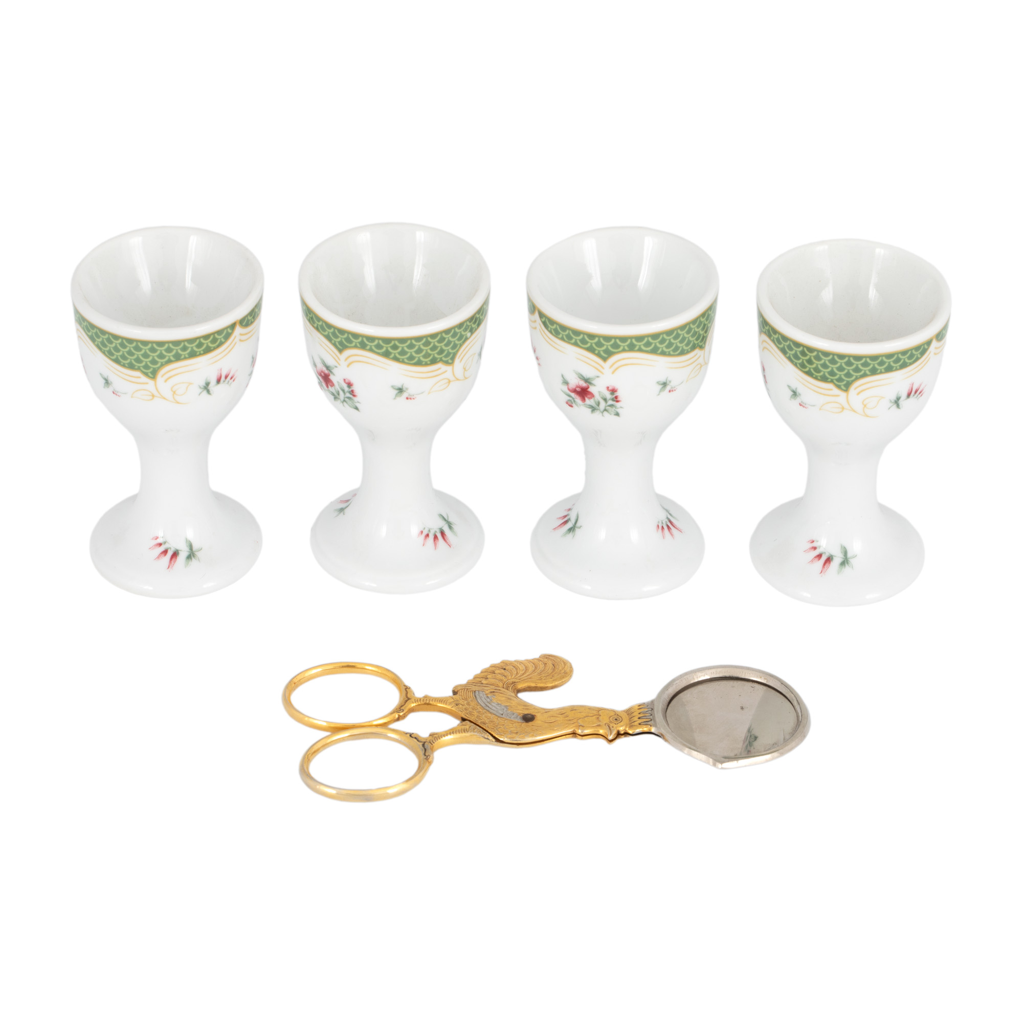 Four-piece set consisting of Bavarian porcelain egg holders and an egg cutter tool, circa 1930